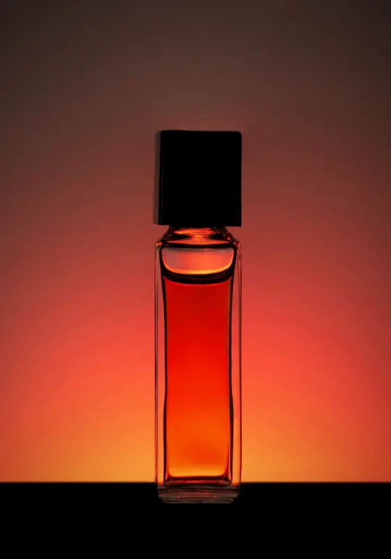 A bottle of Araar Najd, the house signature, its amber liquid glowing against warm light