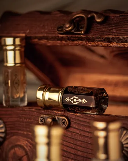 Oil bottles with gold caps inside a carved wooden chest