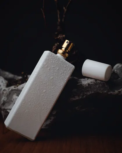 The white Harir bottle leaning on a dark stone