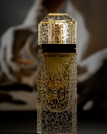 The clear Majlis bottle, engraved with gold ornament