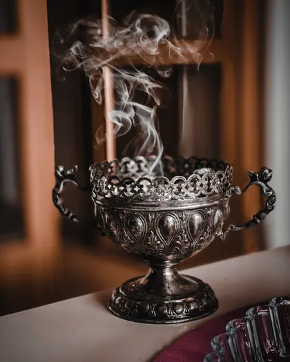 An engraved silver mabkhara with smoke rising